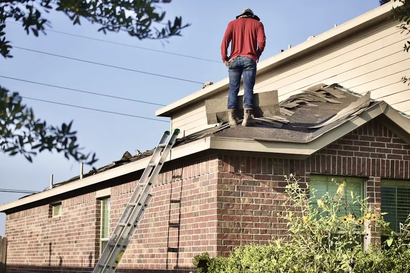 Professional roofer working on a residential roof in Sandpiper Golf and Country Club